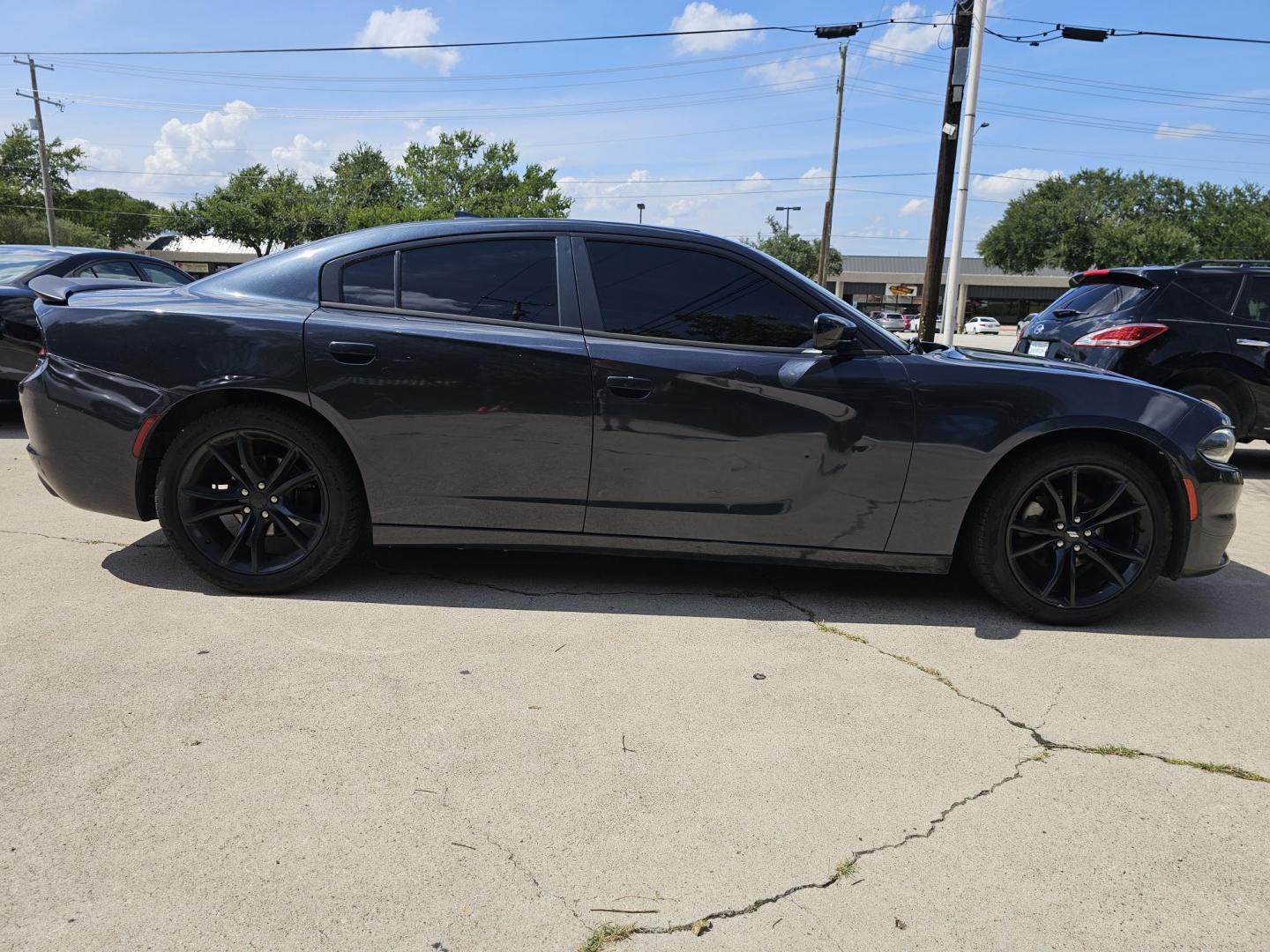 2016 GRAY /Dark Gray Dodge Charger SXT (2C3CDXHGXGH) with an 3.6 engine, Automatic transmission, located at 2020 East Division Street, Arlington, TX, 76011, (817) 801-3191, 32.742390, -97.076874 - This storm gray Dodge Charger is here for your next ride! Come check it out at DFW Carmart today! Premiere Buy Here Pay Here with NO Credit Check (score) at 2020 East Division Street, Arlington, Texas, located in the center of the Dallas/Fort Worth metro area. For in-house financing in Lancaster, - Photo#1